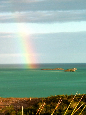 A rainbow appears over the little cays off the south side of Provo.