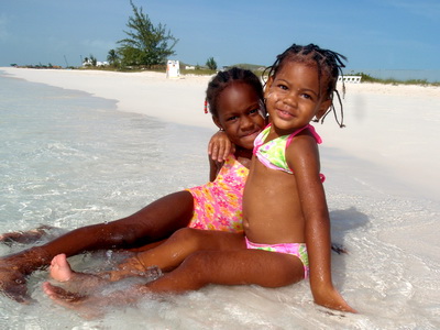 Smiling kids having fun in the calm waters of Grace Bay
