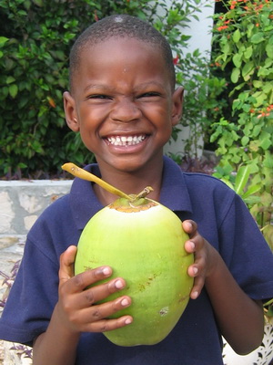 Our godson Olique picks his first coconut that he wants to have a taste of.