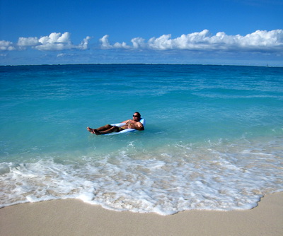 Mike floating about on Grace Bay beach at the Bay Bistro