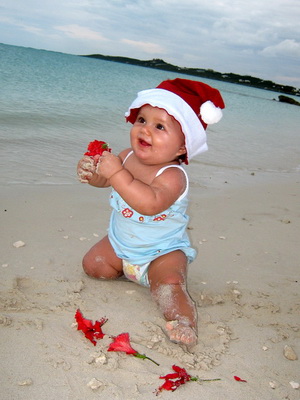 Red hibiscus and a red Santa hat as Malaika enjoyed the sand at the beach