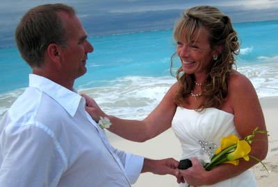 Dan and Faith are all smiles as they exchanged vows on Leeward beach. 