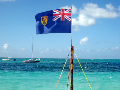 The Turks and Caicos Islands flag flew proudly ontop of one of the rafts while a Caicos Sloop lay at anchor just off the shore