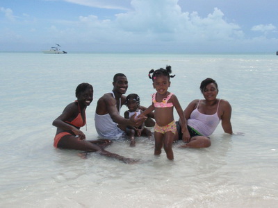 The whole family posed together in the shallows.