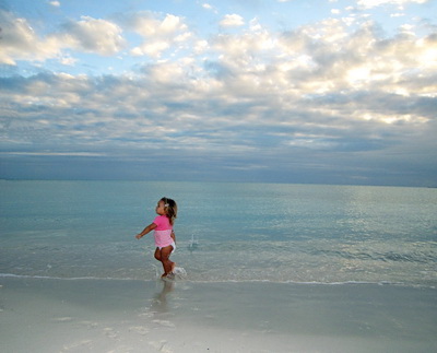 Sunset this evening was through a bank of clouds creating a gentle, pastel palette of colours. Malaika enjoyed running back and forth as she threw rocks and bits of coral into the water. Little puffy clouds with a sky blue background completed a tranquil moment captured on my camera